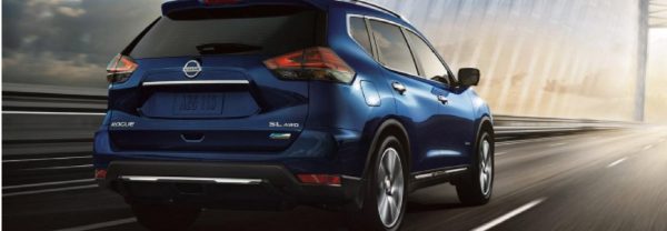 The 2018 Nissan Rogue driving down the road.